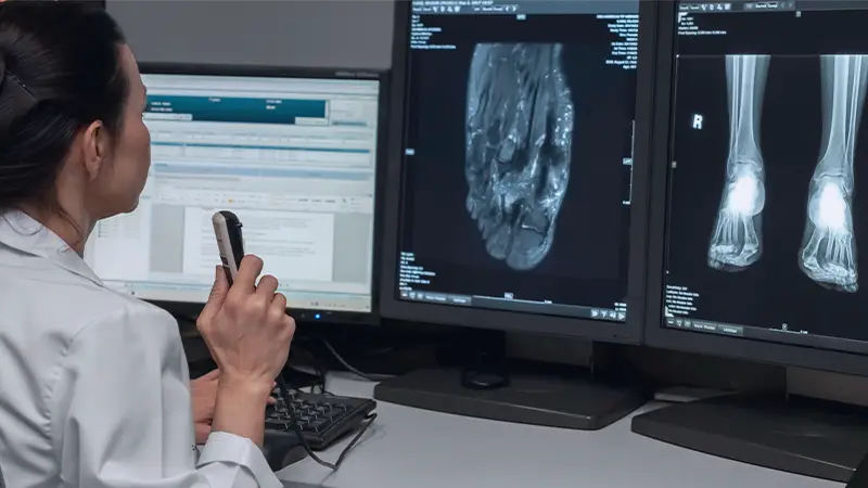 Dr reviewing foot x-ray and dictating