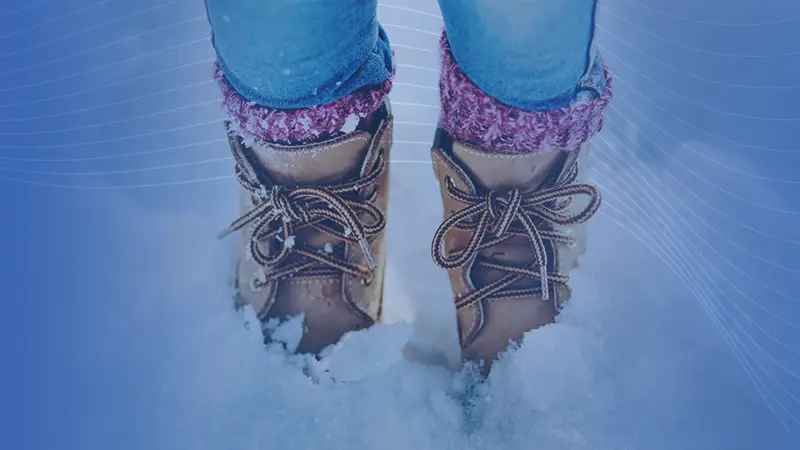 person wearing boots in the snow