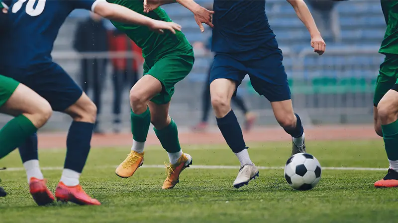 Soccer game on a grass field.